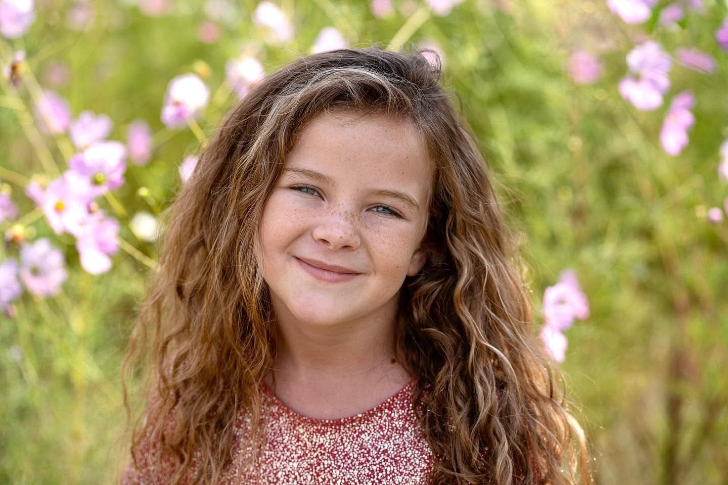 Portrait of a young girl in a field of wildflowers