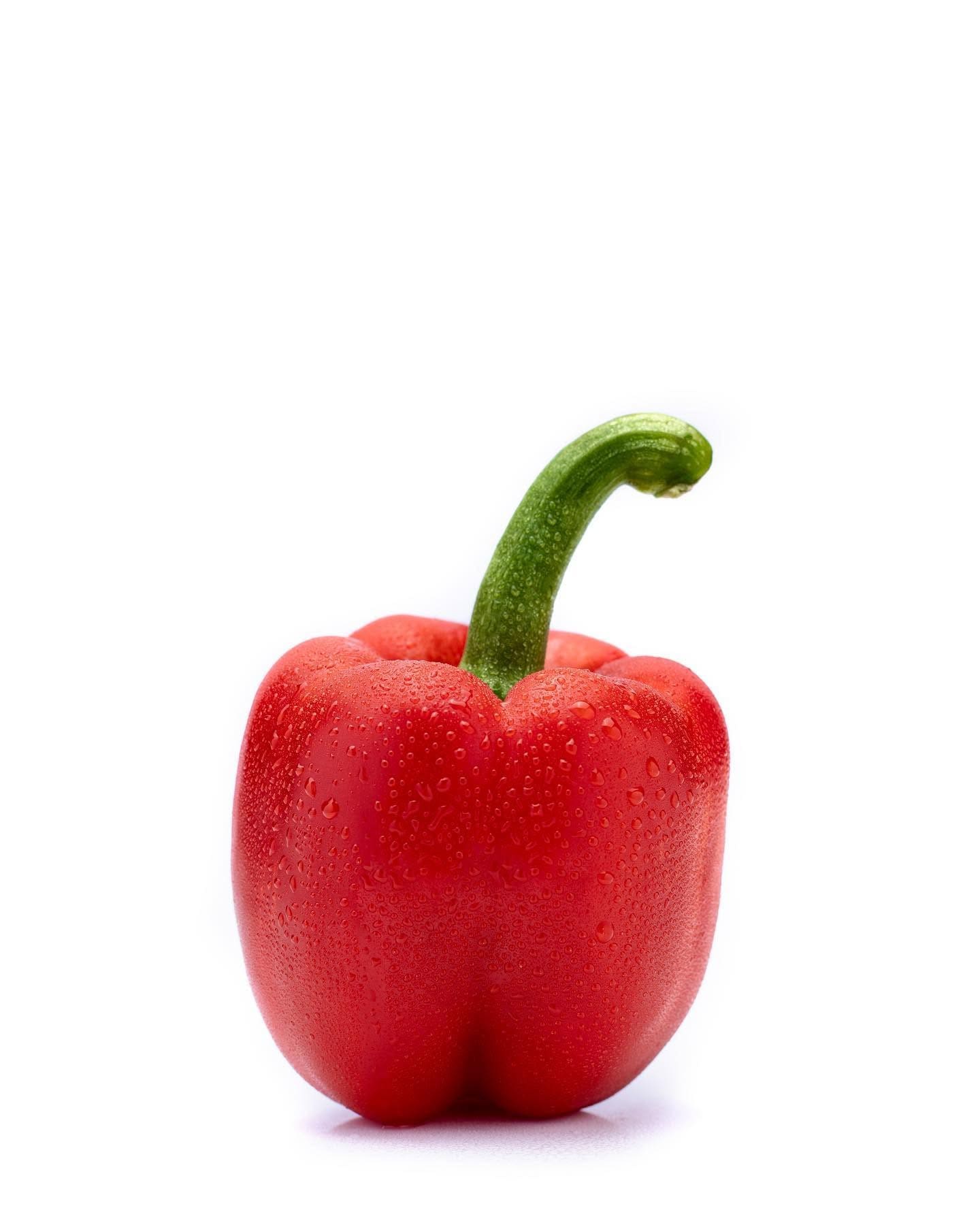 Single red bell pepper on a clean background