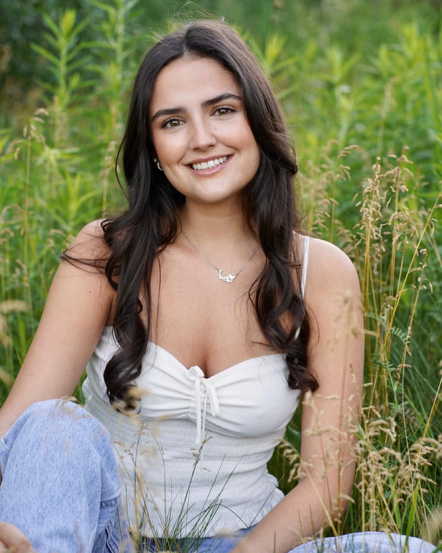 Editorial brand portrait of a woman outdoors in greenery